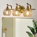 ANDY STAR Bruhsed Gold Bathroom Light Fixtures, Gold 3 Light Bathroom Vanity Lights, 3 Lights Wall Light with Globe Clear Lampshade, Vintage Brass Sconce with Metal Lamp Body for Bedroom, Living Room